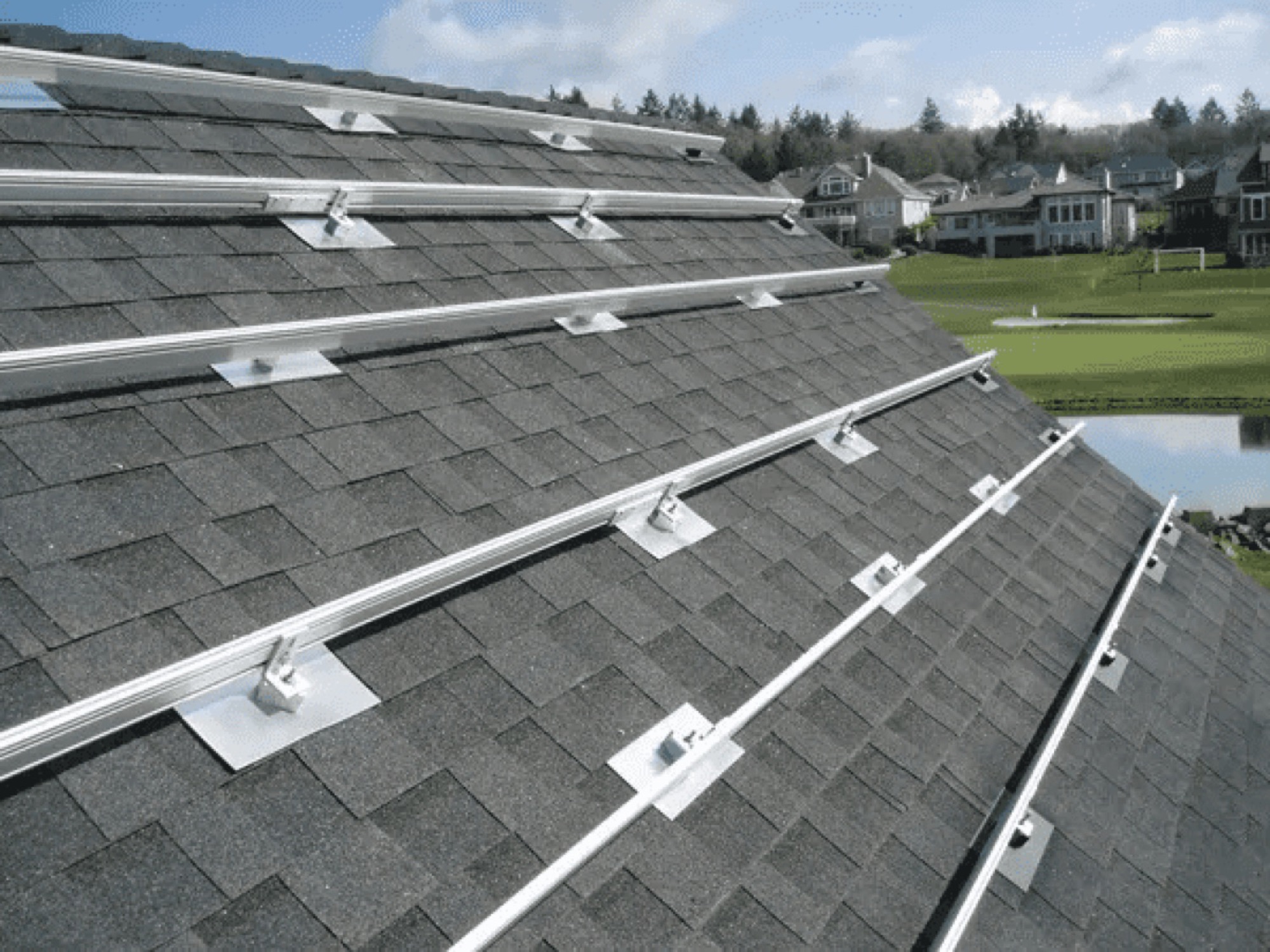 Solar mounting rails and flashing installed on a new shingle roof